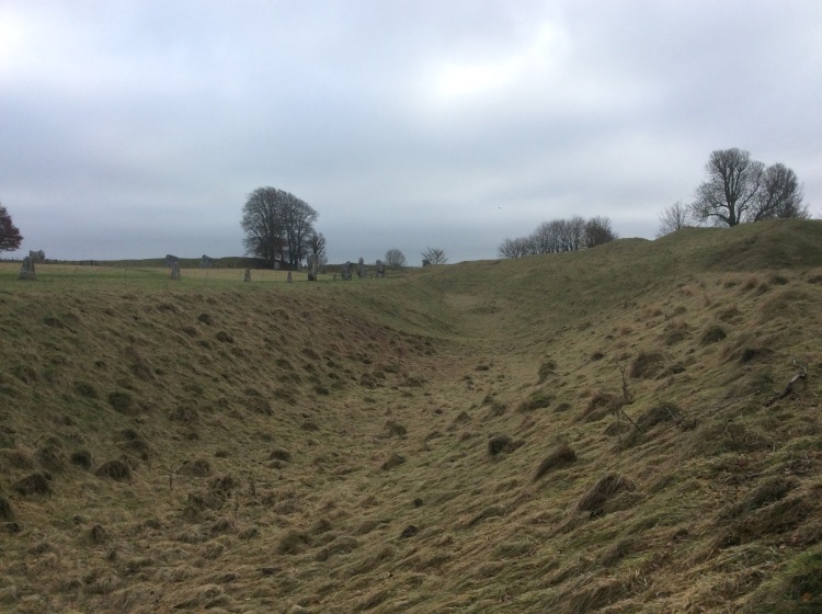 The outer ditch and earthen heap that encircles the mile wide Avebury Stone-circle