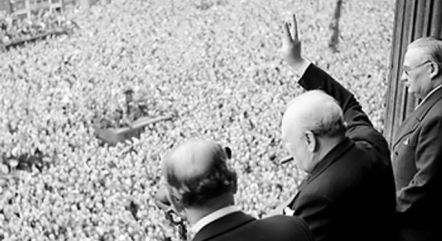 PM Sir Winston Churchill giving one of his many V gestures to the assembled crowds.